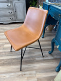 Whiskey brown faux leather chairs