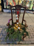 Chair with cedar greens and jingle bell balls