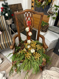 Chair with cedar greens and jingle bell balls